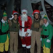 Christmas in Iraq. 2nd from left: Capt. Jennifer Harris. To the right of Santa is LtCol Sean Killeen. Photo courtesy of Tony and Linda Macone. 