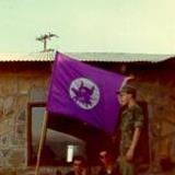 Cpl James H. Bandish with HMM-364 Flag at Squadron Party, EM Club at Marble Mountain - 1969. Photo courtesy of Jim Bandish.