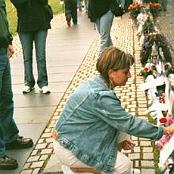 Me placing my father's wings at his name on The Wall - Memorial Day, 2003.